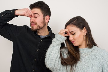 Very upset, charming, nice woman touching nose between closed eyes, want to cry, having stressful...