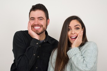 Surprise astonished beautiful girl looking surprised in full disbelief wide open mouth with hand near face. Positive emotion facial expression body language.