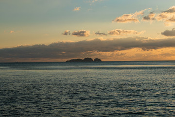 small island on a sunset in the middle of the sea