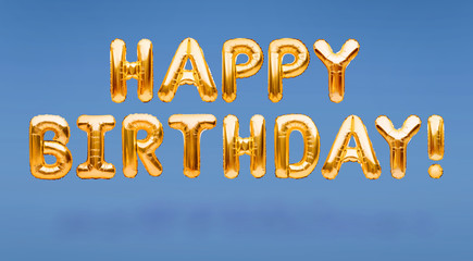 Words HAPPY BIRTHDAY made of golden inflatable balloons floating on blue background. Gold foil helium balloons forming phrase. Birthday congratulations concept, HBD phrase, happy birthday wishes