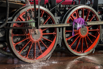 Fototapeta na wymiar cleaning historical steam locomotive