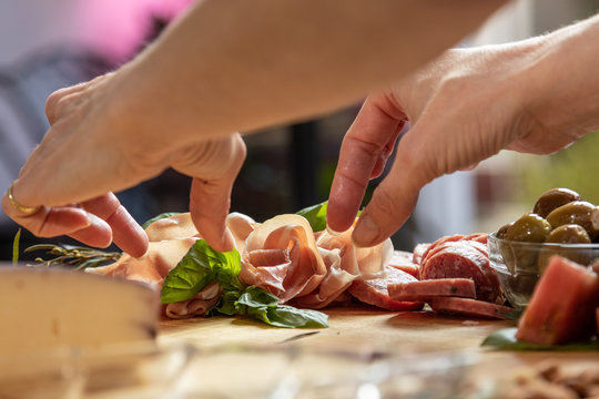 Placing Food On Gourmet Charcuterie Board