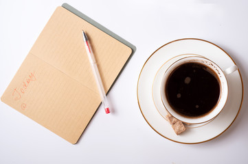 cup of coffee with diary, and care cosmetics  around white background. life style flat lay