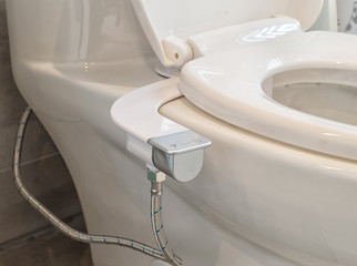 Way to save toilet tissues by using toilet bidet seat add on during covid 19 pandemic - obrazy, fototapety, plakaty