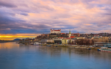 Bratislava shore with castle during twilight in cloudy weather.