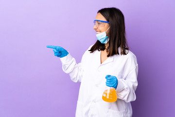 Scientist woman investigating a vaccine to cure coronavirus disease pointing finger to the side