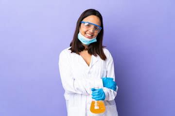 Scientist woman investigating a vaccine to cure coronavirus disease laughing