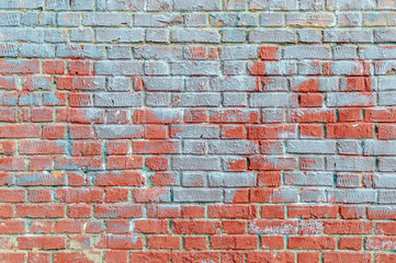Old brick wall with traces of paint.