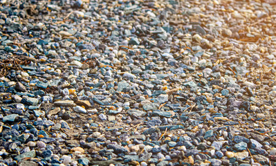 many small coastal pebbles. beach sand from stones close-up.