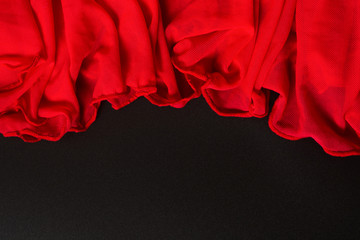 Beautiful red textile waving texture on black background