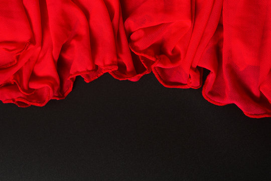 Beautiful red textile waving texture on black background