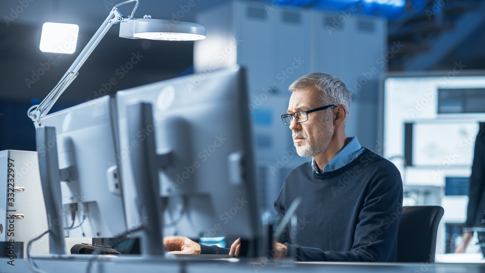 Aufkleber Shot of Industrial Engineer Working in Research Laboratory / Development Center, Using Computer. He is Working on New Efficient Engine Concept Design.