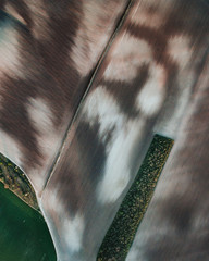 Aerial view ; Rows of soil before planting.Furrows row pattern in a plowed field prepared for planting crops in spring.Horizontal view in perspective.