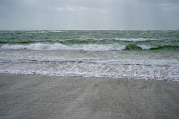 Waves lapping on a sandy beach shore