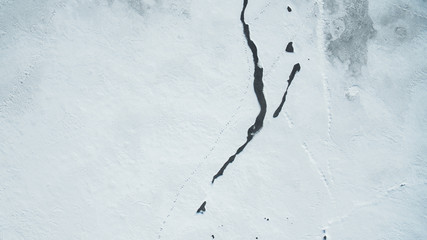 Texture of Frozen Lake Covered with snow Aerial Vertical Top-Down View