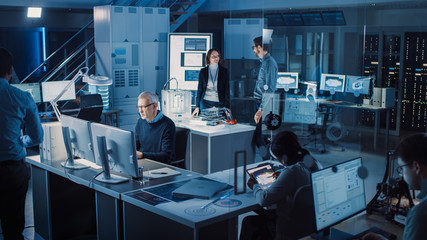 Diverse International Team of Industrial Engineers and Scientists Working in Research Laboratory / Development Center. People Working on Efficient Engine Design, Using Computers, Advanced Technology
