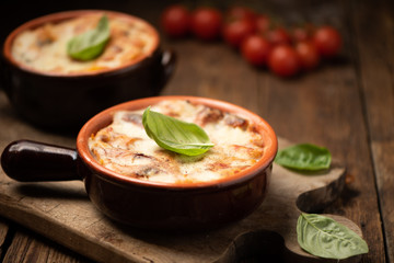 Lasagna dish on a rustic table. Food, mozzarella.