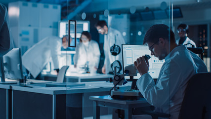 Shot in Industrial Design Research Laboratory, Specialist Uses Microscope, Designer Works on PC, Female Scientists Writes on Glass Whiteboard, Team of Developers Work with 3D Printer and Motherboard.