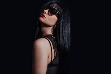 Fototapeta na wymiar woman posing with glasses on black background
