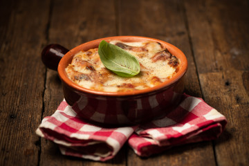 Lasagna dish on a rustic table. Food, mozzarella.