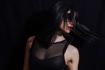 Fototapeta premium woman posing with glasses on black background