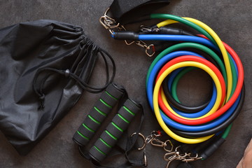 Sports accessory - expander with a carbine on a dark background.