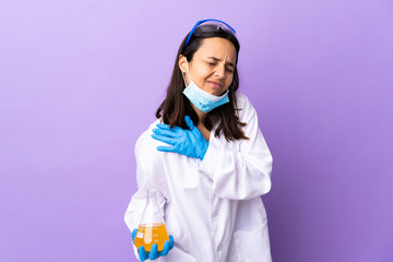 Scientist woman investigating a vaccine to cure coronavirus disease suffering from pain in shoulder for having made an effort