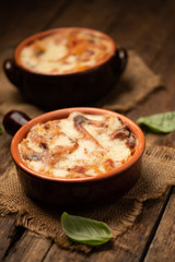 Lasagna dish on a rustic table. Food, mozzarella.
