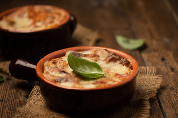 Lasagna dish on a rustic table. Food, mozzarella.