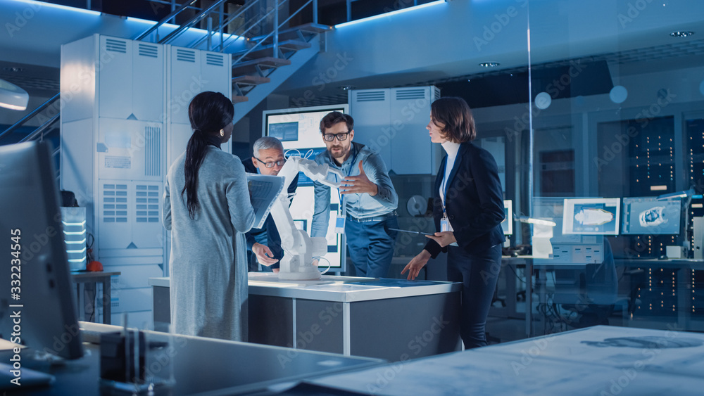 Poster Engineers Meeting in Robotic Research Laboratory: Engineers, Scientists and Developers Gathered Around Illuminated Conference Table, Talking, Using Tablet and Analysing Design of Industrial Robot Arm