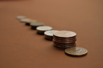 small stacks of coins on the root background going into the distance