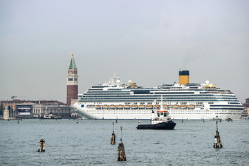 Tug boat and cruise liner in front of Doges palace in summer Venice