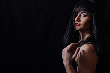 woman posing laughing on black background