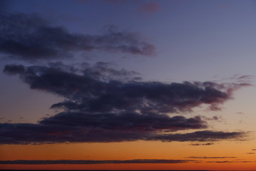 Fototapeta na wymiar Sea sunset with big clouds