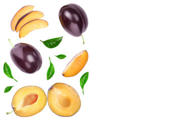 fresh purple plum and half with leaves isolated on white background with clipping path and copy spase for your text. Top view. Flat lay