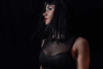 Fototapeta na wymiar woman side face posing on black background