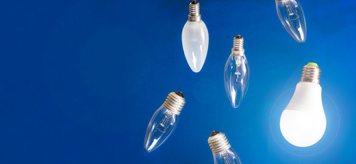 Different bulbs fall down. Electric lighting. Blurred background. Power saving LED lamps in...