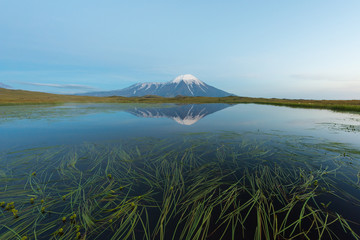 Tolbachik volcano reflection in the quiet mountain lake, Kamchatka