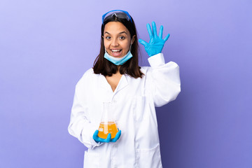 Scientist woman investigating a vaccine to cure coronavirus disease counting five with fingers