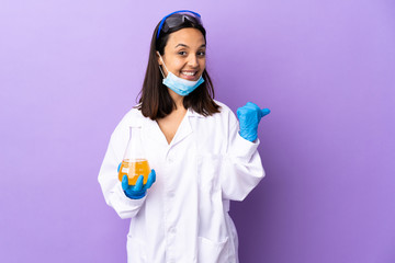 Scientist woman investigating a vaccine to cure coronavirus disease pointing to the side to present...