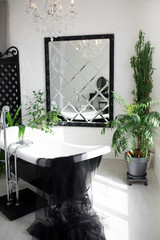 Exclusive modern black and white bathroom interior in luxury mansion with big window