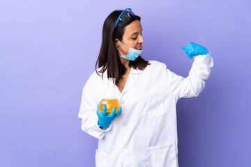 Scientist woman investigating a vaccine to cure coronavirus disease doing strong gesture