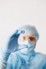 Close up of doctor hand holding. Mock up. Medical equipment. A doctor wearing personal protective equipment including mask, goggle, and suit to protect COVID-19 coronavirus infection.