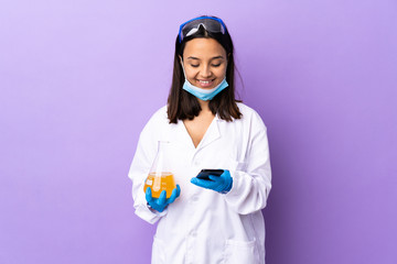 Scientist woman investigating a vaccine to cure coronavirus disease sending a message with the...