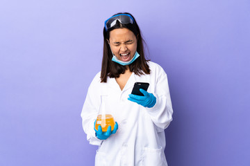 Scientist woman investigating a vaccine to cure coronavirus disease with phone in victory position