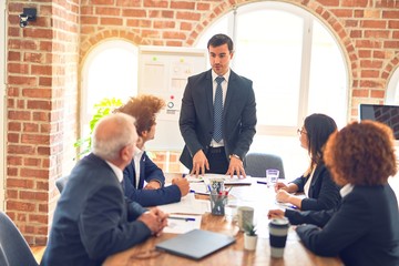 Group of business workers working together in a meeting. Listening one of them speaking at the office.