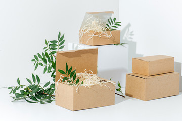 Recyclable paper boxes in the corner over white background