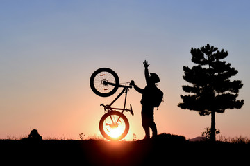 young man having peak adventures with mountain bike