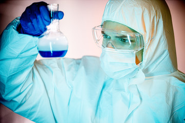 corona virus concept. male doctor reviewing glass flask