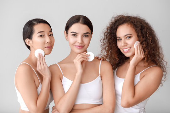 Beautiful Young Women With Cotton Pads On Light Background